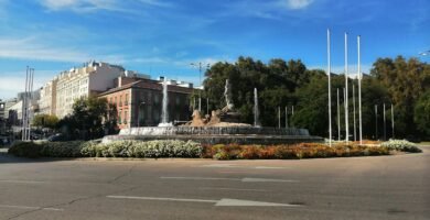 a large building with a fountain in the middle of it